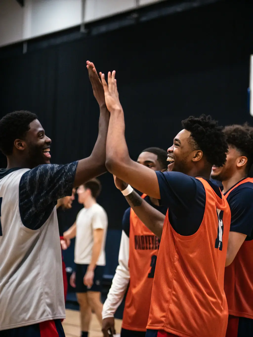 An image of a basketball team high-fiving after scoring a point, emphasizing the spirit of teamwork and collaboration.